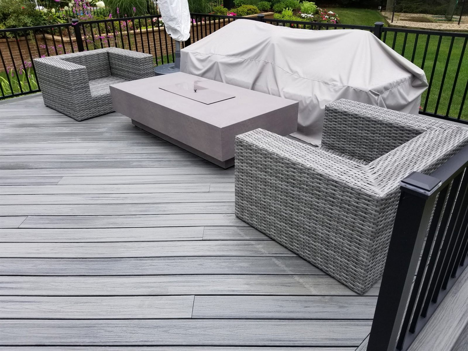 Composite deck with a fire table built by Level Line in Bellmore, NY