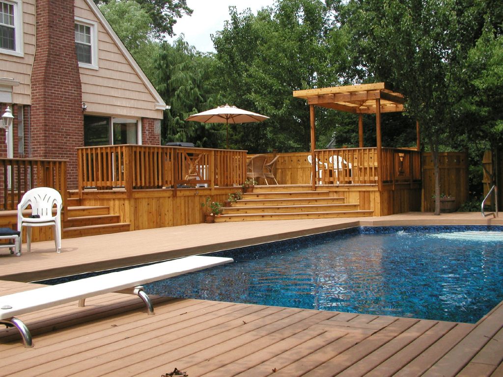 Pool deck with wooden pergola shade structure
